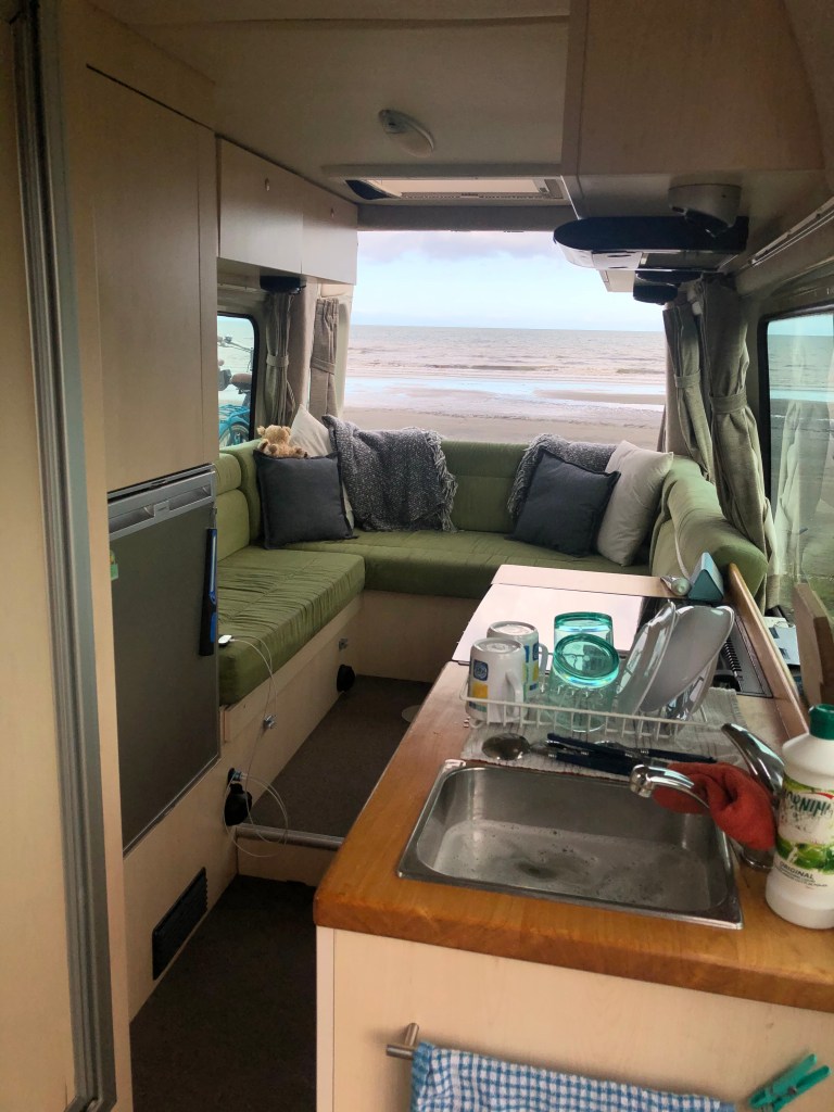 washing up views from the Kiwi Blog Bus Campervan parked up with views out to the sea
